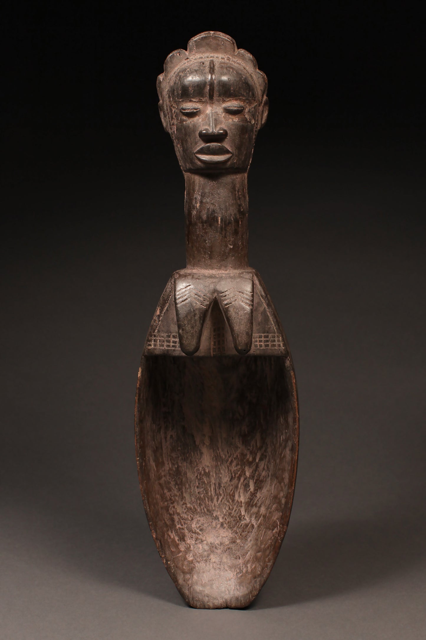Tribal Objects - African Tribal Art - Ancient Ceremonial Art - Handcrafted Artifacts - Masks - Wood Sculptures - Iron Bronze Objects - Textiles - Art Pieces - African Folk Art - This authentic Ceremonial Ladle Spoon from the Dan Tribe in Liberia, Ivory Coast is carved from wood and features unique figures and artifacts. An ideal piece for collectors, the spoon is a great way to commemorate traditional culture. 22" x 6.25" Inventory # 10308