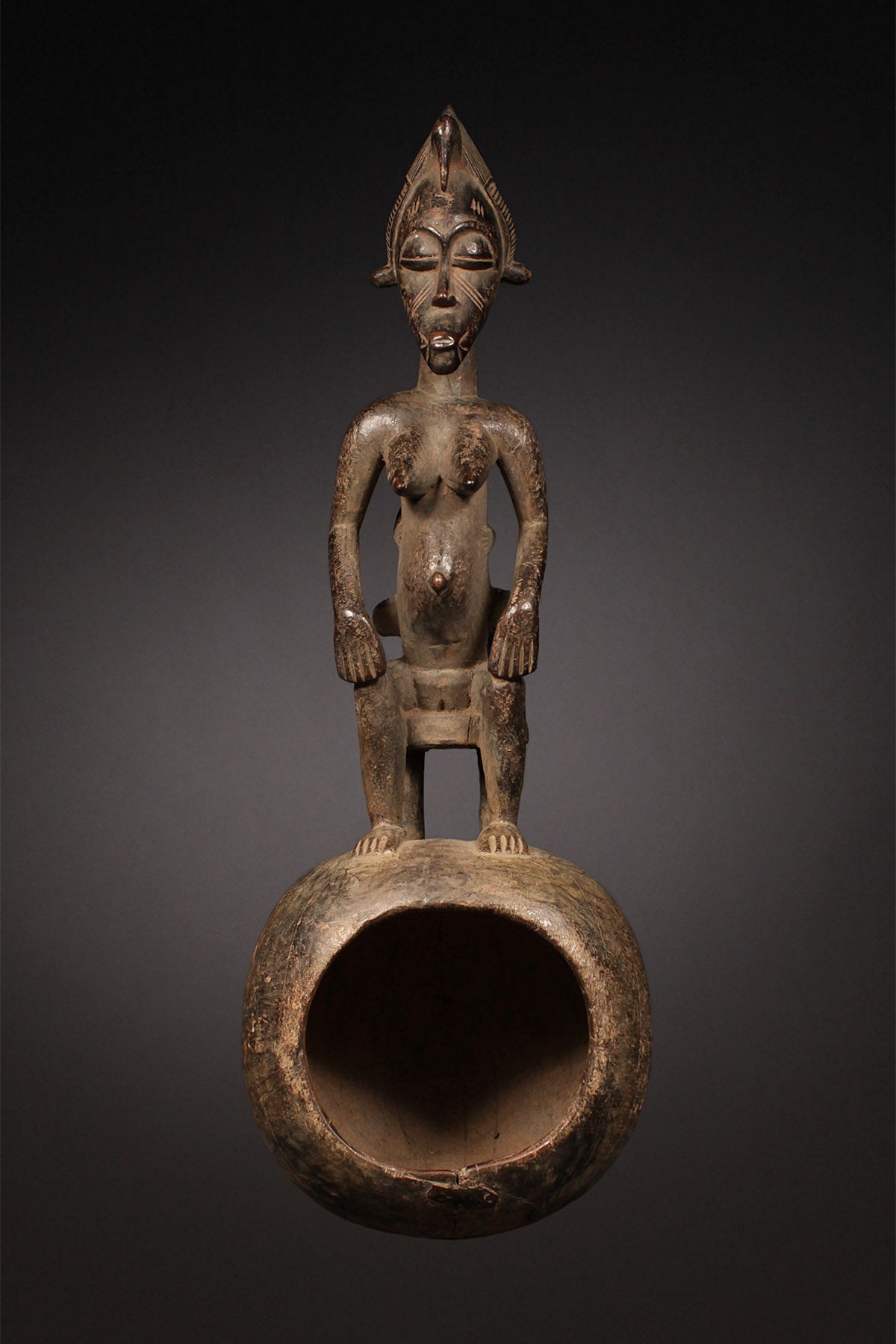 Tribal Objects - African Tribal Art - Ancient Ceremonial Art - Handcrafted Artifacts - Masks - Wood Sculptures - Iron Bronze Objects - Textiles - Art Pieces - African Folk Art - This Senufo Ceremonial Spoon and Maternity Figure is a unique collectible from the Senufo Tribe of the Ivory Coast. Crafted by hand with wood and featuring a maternity figure, this piece is an excellent addition to any African artifact collection. H: 16" Inventory # 10398