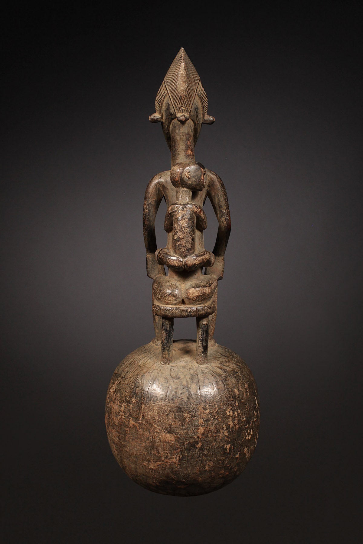 Tribal Objects - African Tribal Art - Ancient Ceremonial Art - Handcrafted Artifacts - Masks - Wood Sculptures - Iron Bronze Objects - Textiles - Art Pieces - African Folk Art - This Senufo Ceremonial Spoon and Maternity Figure is a unique collectible from the Senufo Tribe of the Ivory Coast. Crafted by hand with wood and featuring a maternity figure, this piece is an excellent addition to any African artifact collection. H: 16" Inventory # 10398
