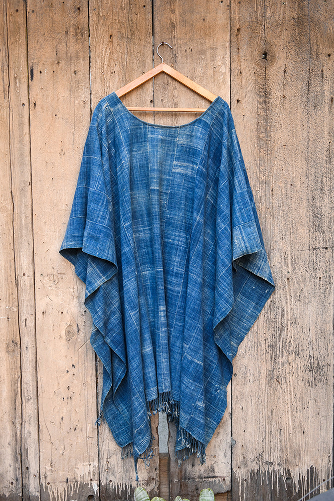 Experience traditional African style with our Faded Blue Indigo Poncho. Made with high-quality African textile, this poncho is both stylish and comfortable. Perfect for any occasion, the faded blue color adds a unique touch to any outfit. Elevate your wardrobe with this one-of-a-kind piece.