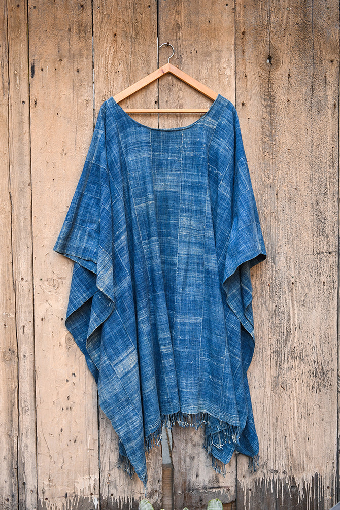Experience traditional African style with our Faded Blue Indigo Poncho. Made with high-quality African textile, this poncho is both stylish and comfortable. Perfect for any occasion, the faded blue color adds a unique touch to any outfit. Elevate your wardrobe with this one-of-a-kind piece.