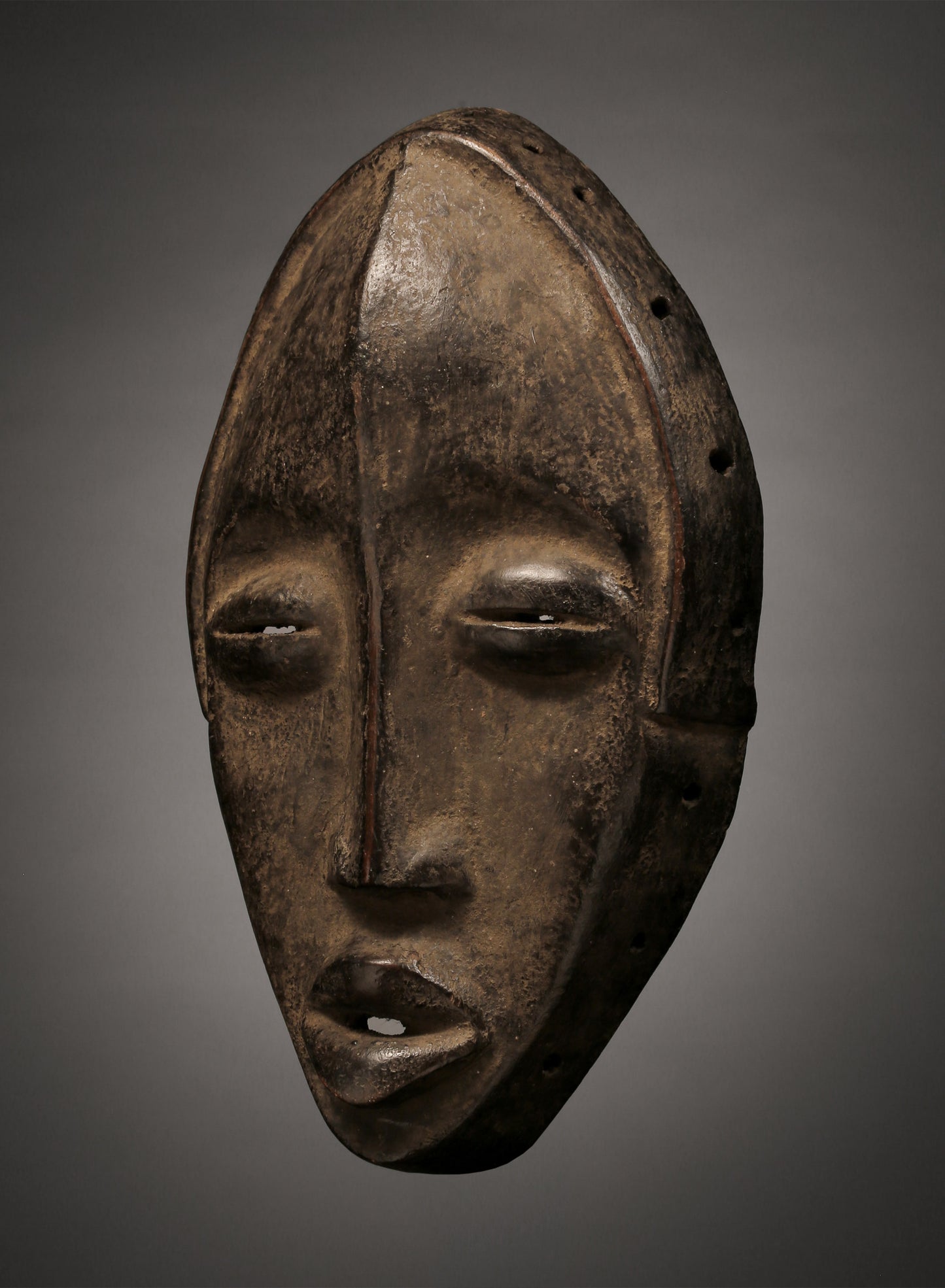 Tribal Masks - Handcrafted - Dan Masks - Traditional Folk Art - African Artifacts Sculptures - African Art Collector - This Carved Wooden Deangle Dan Mask is an authentic work of African art from the regions of Liberia or Ivory Coast, making it an ideal addition to any art collection. Made of wood, this mask features intricate carvings, perfect for showcasing its age and authenticity. Heigh: 9.5 inches Width: 5.5 inches