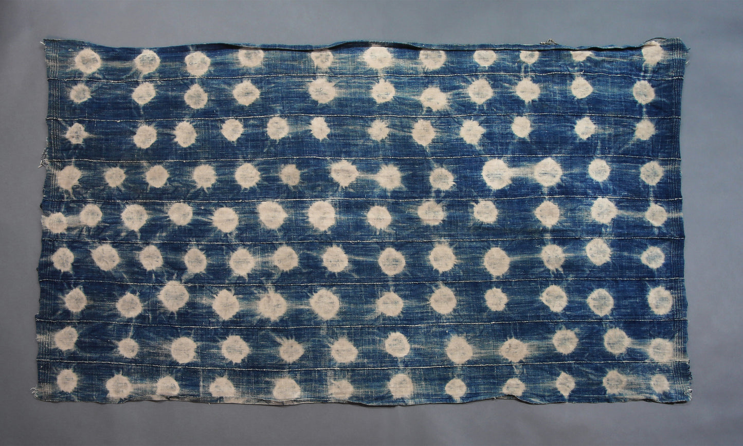 Handcrafted Textiles - Artisan Designed - Handcrafted African Art Textiles - Home Decor - Living Spaces - Mix Colors - Bold Patterns - Traditional Designs - African Culture - This Faded Indigo Scarf Tie Dye Fabric is a vintage African textile shawl that combines a signature faded blue hue with classic tie dye pattern. Crafted from high-quality fabric, this shawl is sure to bring a timeless style to your wardrobe. 60" X 32" Inventory # 10821