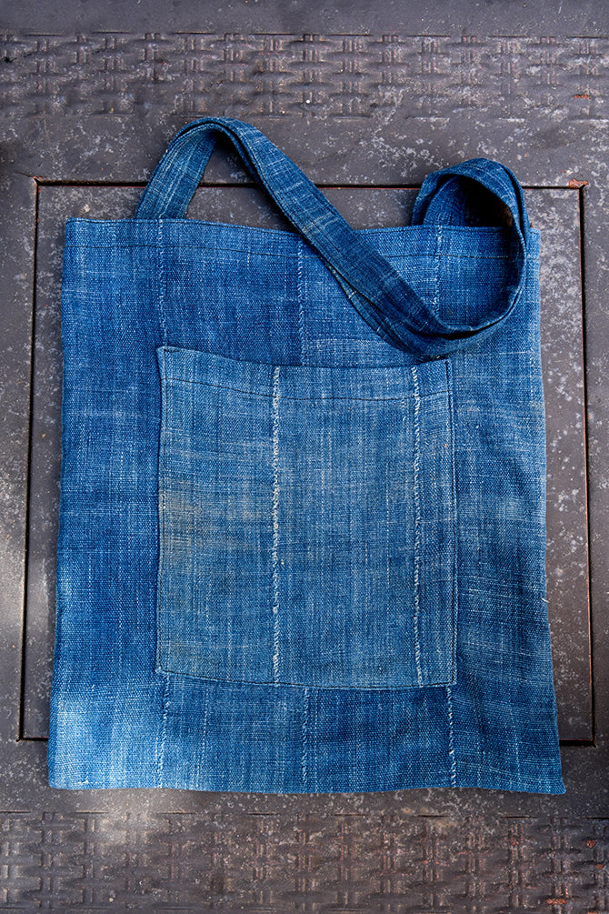 Handcrafted Bags - Artisans Designer - Handbags - Bags - Handcrafted Art Bags - Accessories - One - of - a - kind - Product - Quality Materials - Stylish Products - Durable - This African Indigo Dyed Fabric Tote Bag is an eco-friendly choice, made from 100% cotton material hand-dyed in traditional African Indigo. The faded blue color is deeply saturated, while a reinforced shoulder handle offers comfortable and durable carrying. This stylish and durable handbag is perfect for everyday use.