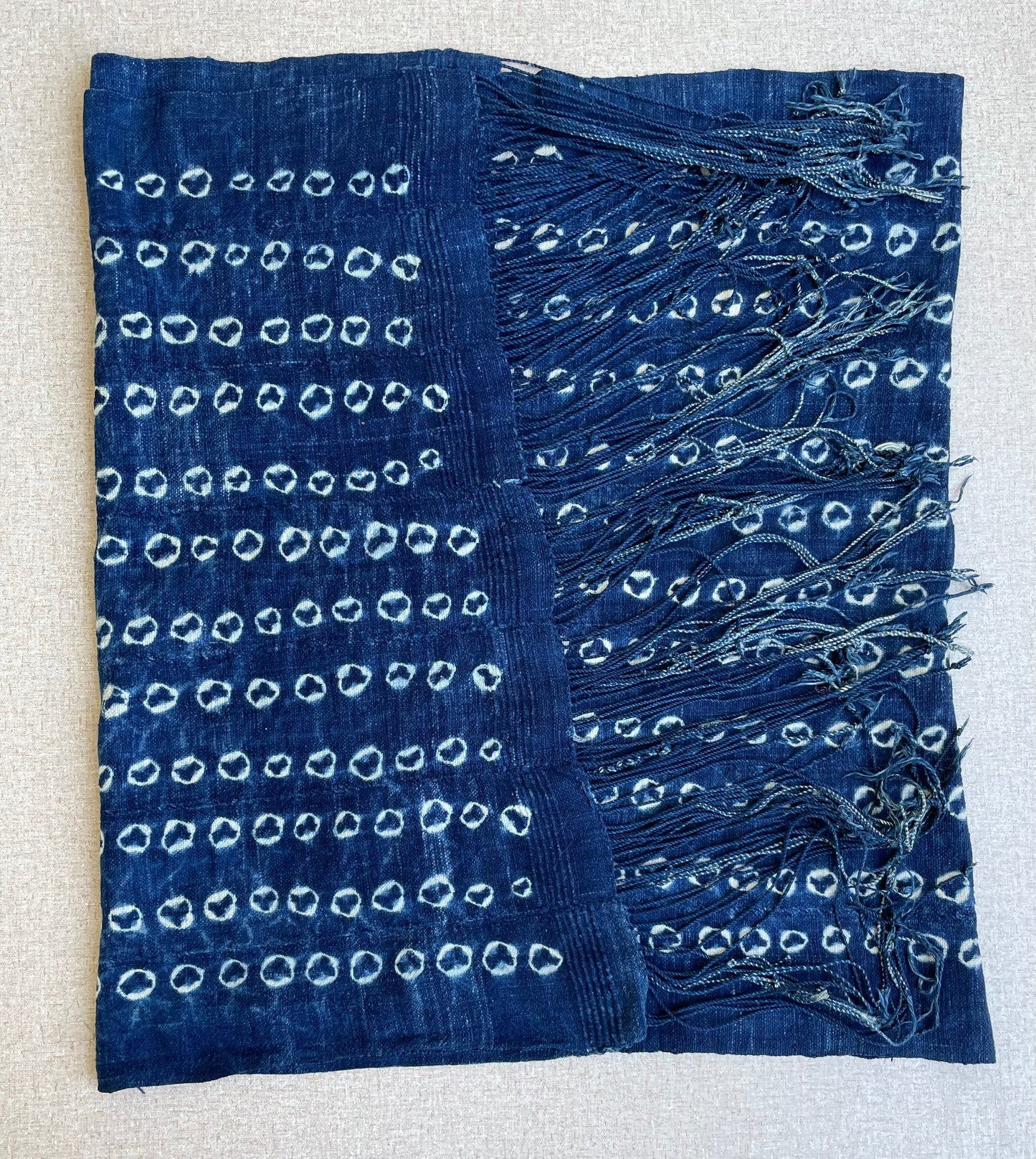 Handcrafted Textiles - Artisan Designed - Handcrafted African Art Textiles - Home Decor - Living Spaces - Mix Colors - Bold Patterns - Traditional Designs - African Culture - This Indigo Shibori Tie Dye Cotton Fabric is a stunning combination of African textile and hand-dyed color. Expertly crafted with attention to detail, this beautiful scarf provides long-lasting durability and a unique flair to any ensemble. Length: 63 inches Width: 24 inches