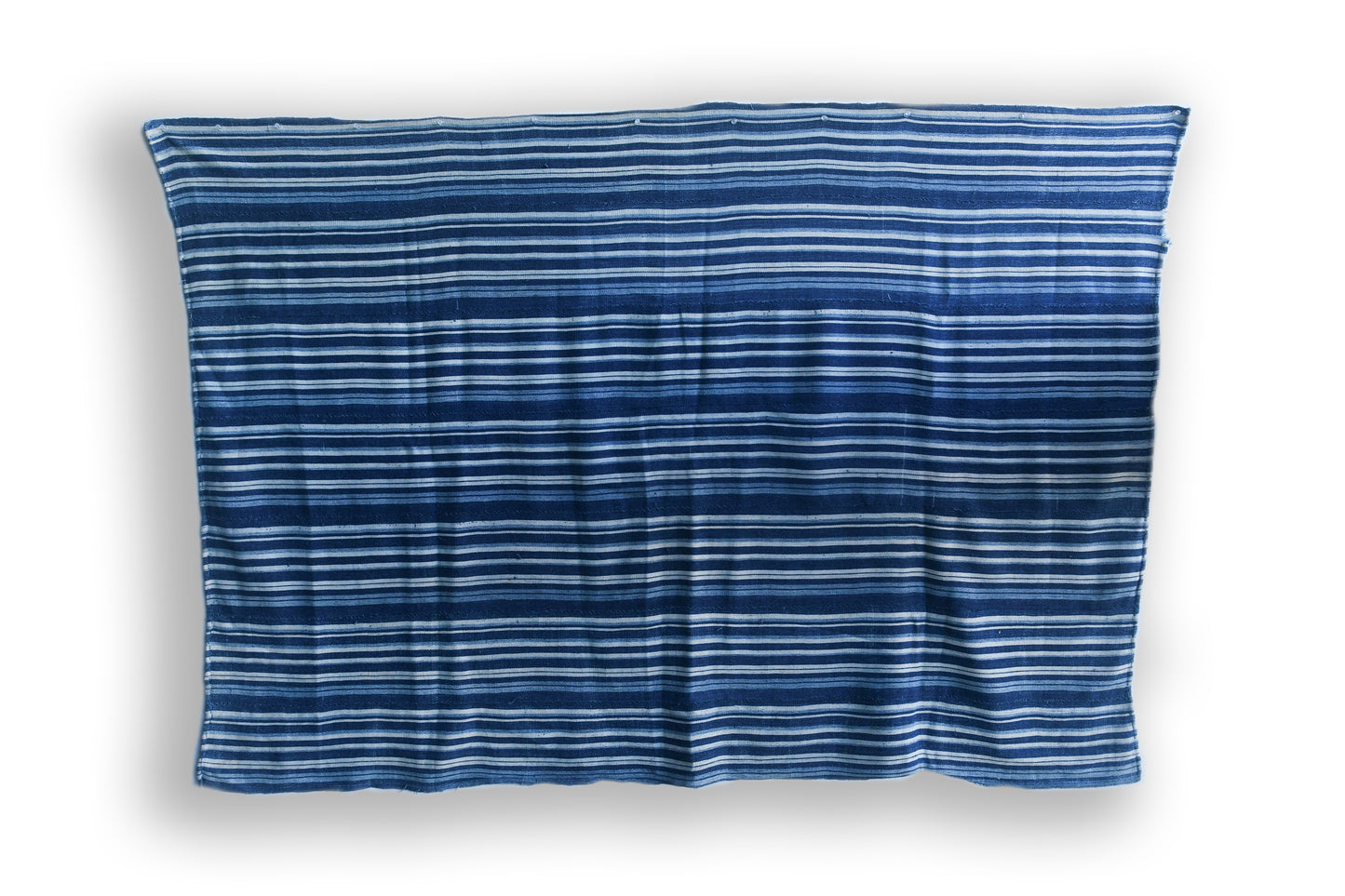 Handcrafted Textiles - Artisan Designed - Handcrafted African Art Textiles - Home Decor - Living Spaces - Mix Colors - Bold Patterns - Traditional Designs - African Culture - Add a unique piece to your home decor with this Indigo Dyed Stripe Woven Textile. This vintage faded blue cotton fabric is an authentic African Mossi textile, perfect for making a statement in any living space. Crafted with premium detail and care, it is suitable for both everyday use and collections. Length: 61 inches Width: 42 inches