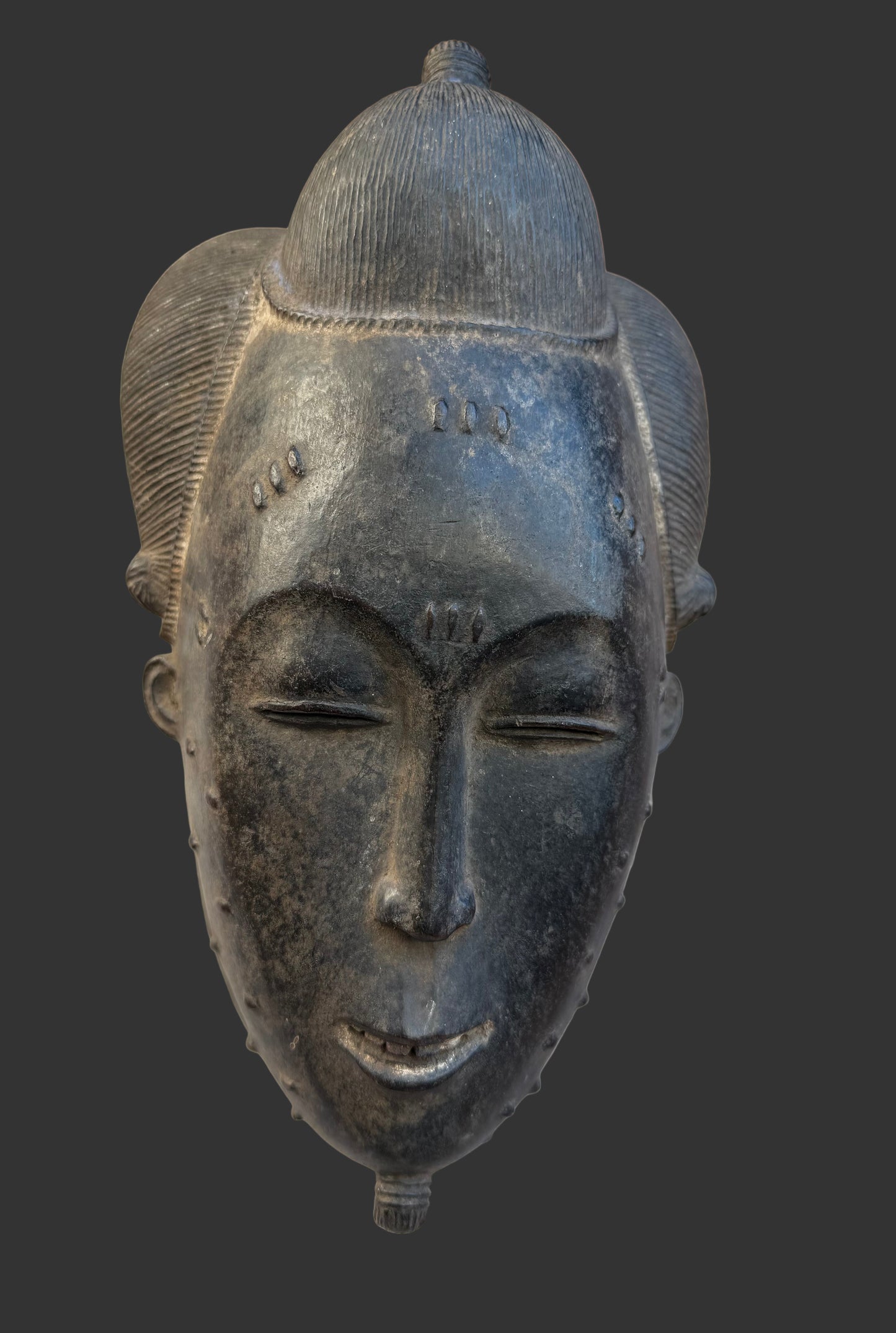 Black African mask on a textured beige background