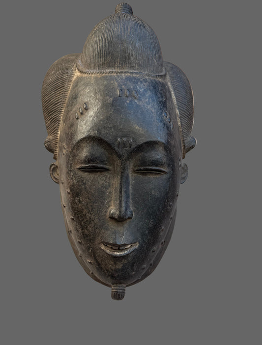 Decorative mask on a wooden surface