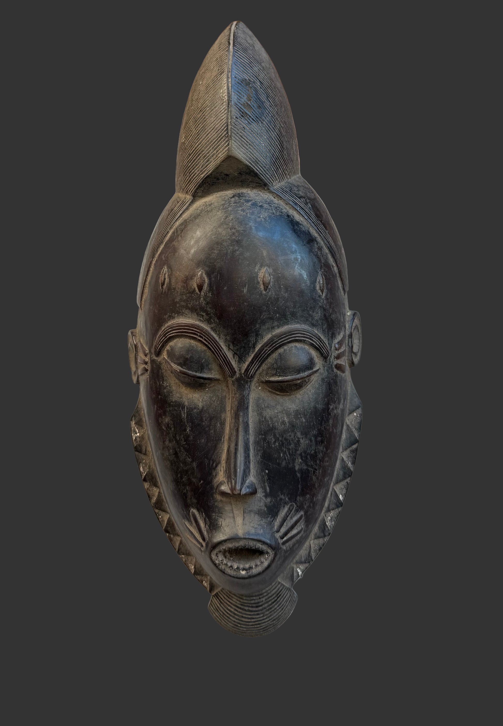 Black African mask on a wooden surface