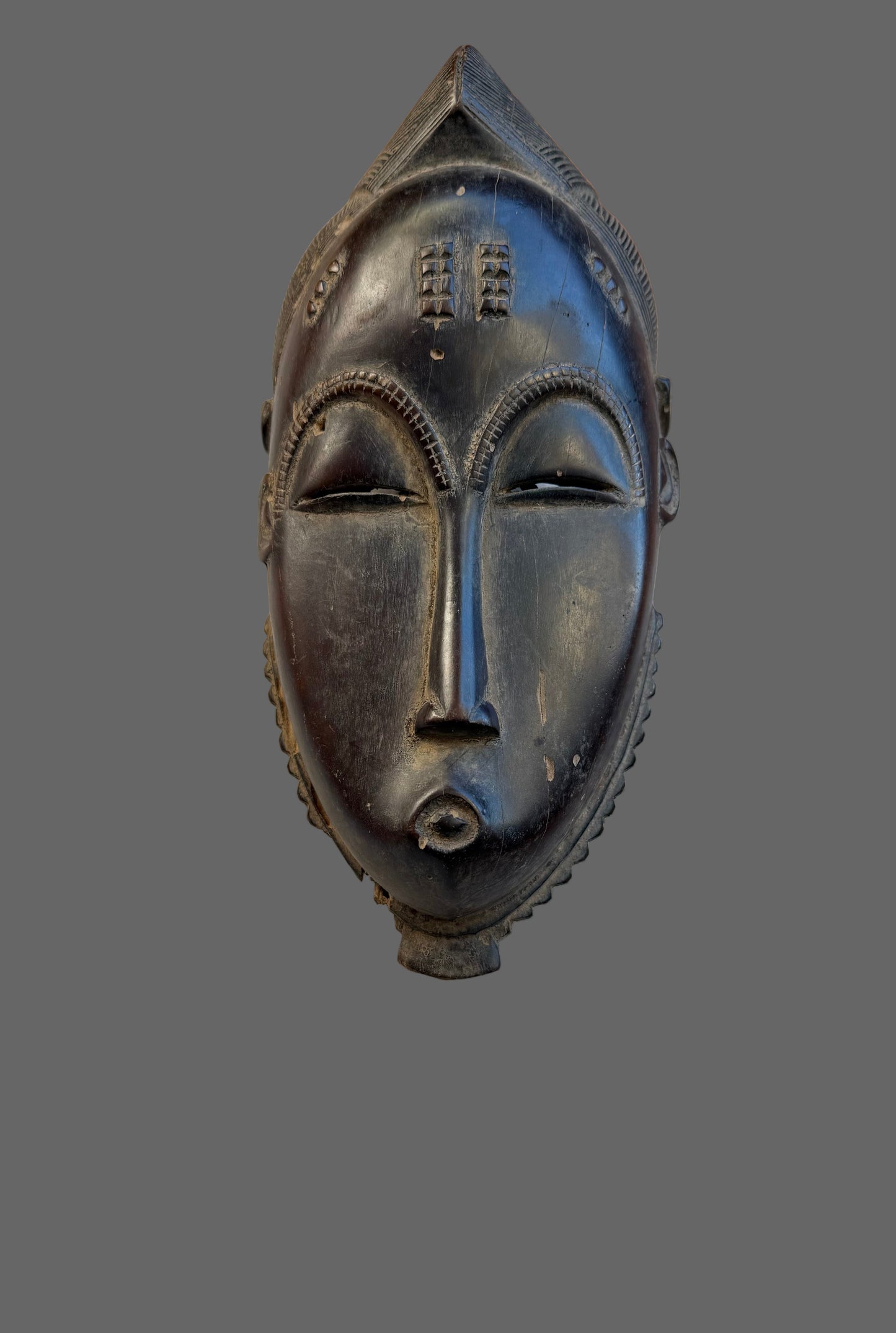 Black mask on a wooden surface