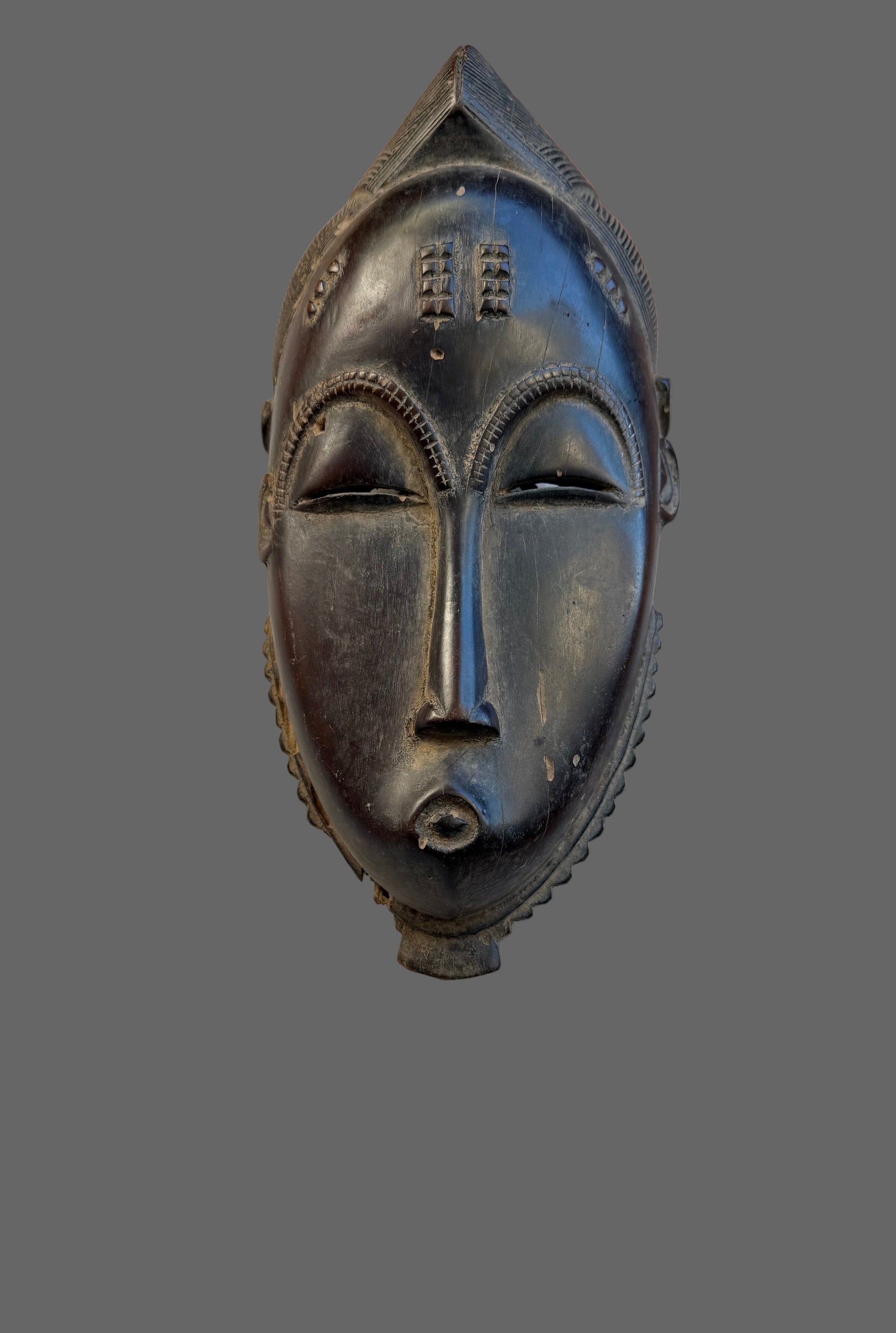 Black mask on a wooden surface