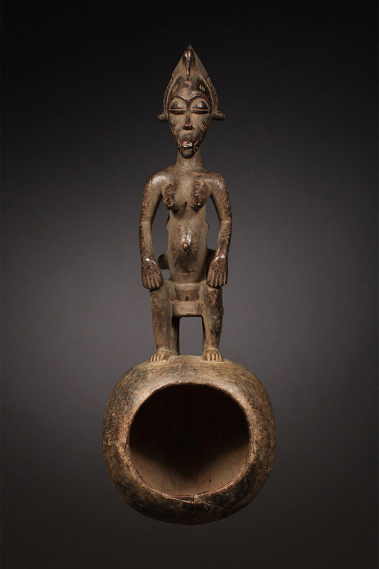 Tribal Objects - African Tribal Art - Ancient Ceremonial Art - Handcrafted Artifacts - Masks - Wood Sculptures - Iron Bronze Objects - Textiles - Art Pieces - African Folk Art - This Senufo Ceremonial Spoon and Maternity Figure is a unique collectible from the Senufo Tribe of the Ivory Coast. Crafted by hand with wood and featuring a maternity figure, this piece is an excellent addition to any African artifact collection. H: 16" Inventory # 10398