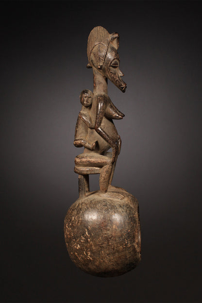 Tribal Objects - African Tribal Art - Ancient Ceremonial Art - Handcrafted Artifacts - Masks - Wood Sculptures - Iron Bronze Objects - Textiles - Art Pieces - African Folk Art - This Senufo Ceremonial Spoon and Maternity Figure is a unique collectible from the Senufo Tribe of the Ivory Coast. Crafted by hand with wood and featuring a maternity figure, this piece is an excellent addition to any African artifact collection. H: 16" Inventory # 10398