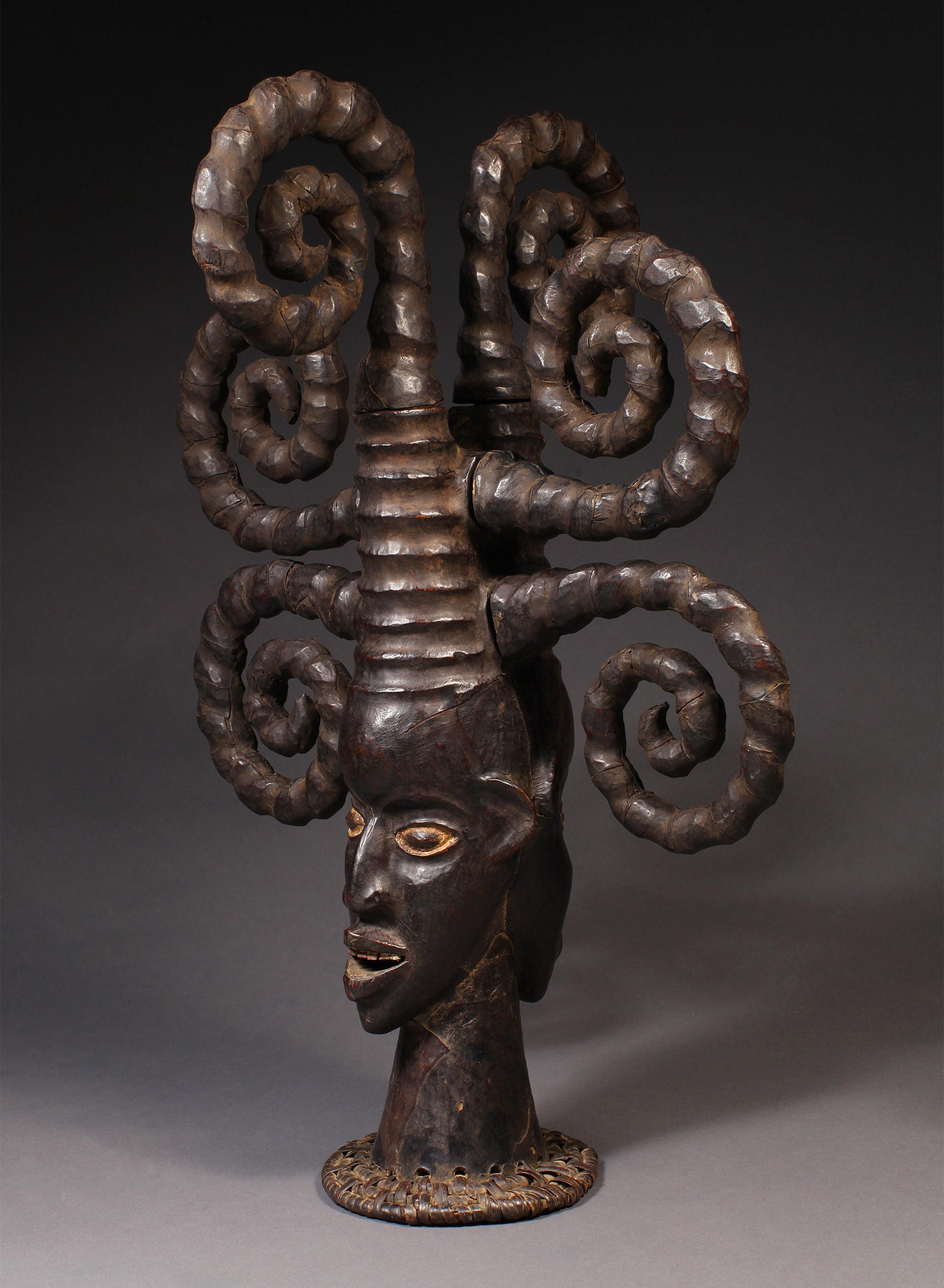 Tribal Masks - Handcrafted - Ekoi Masks - Traditional Folk Art - African Artifacts Sculptures - African Art Collector - This Janus Crest Mask with an elaborate coiffure, crafted by the Ejagham people of the Ekoi tribe in Nigeria, is made of wood and is a unique piece of African art. Its wooden exterior provides strength and durability, while its intricate detailing offers a beautiful addition to any collectors shelf. Height: 34.5"