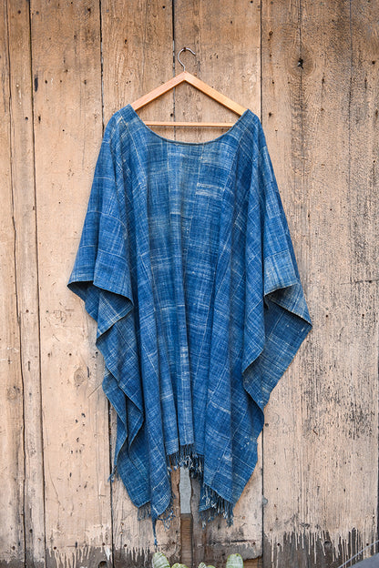 Experience traditional African style with our Faded Blue Indigo Poncho. Made with high-quality African textile, this poncho is both stylish and comfortable. Perfect for any occasion, the faded blue color adds a unique touch to any outfit. Elevate your wardrobe with this one-of-a-kind piece.