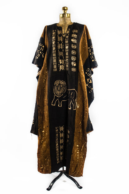 Handcrafted Mudcloth Clothing - African Art - Handmade - Clothing - This Dyed Black Brown Mudcloth Poncho adds a unique, authentic African aesthetic to any ensemble. Crafted with artisanal dying processes and traditional weaving methods, Cotton Bogolan fabric ensures every piece is one-of-a-kind. The natural, handmade look adds an exotic, eye-catching flair to any wardrobe.  Large, Unisex  Full Length: 55"  Inventory # 10715