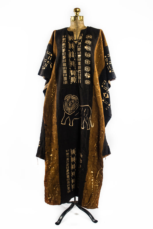 Handcrafted Mudcloth Clothing - African Art - Handmade - Clothing - This Dyed Black Brown Mudcloth Poncho adds a unique, authentic African aesthetic to any ensemble. Crafted with artisanal dying processes and traditional weaving methods, Cotton Bogolan fabric ensures every piece is one-of-a-kind. The natural, handmade look adds an exotic, eye-catching flair to any wardrobe.  Large, Unisex  Full Length: 55"  Inventory # 10715