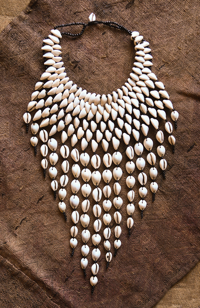 Handcrafted Necklaces - Handmade - African Art - Jewelry - Beaded Necklaces - This Statement Cowrie Shell Necklace is crafted with Authentic Cowrie Shell Beads for a unique and beautiful look.It is a unique piece of African Tribal Jewelry, sure to make a statement. Handmade with love, this is the perfect accessory for any wardrobe. Length: 18" Inventory # 10826