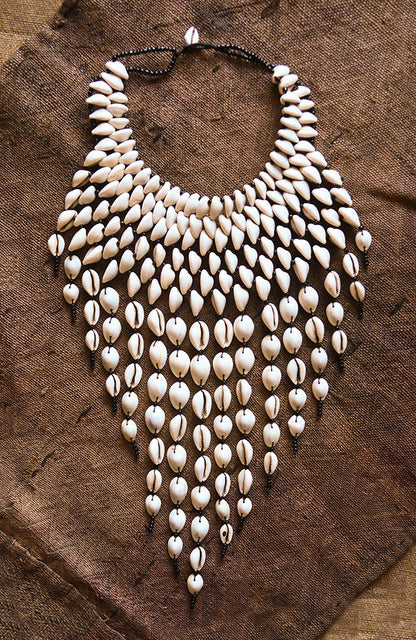 Handcrafted Necklaces - Handmade - African Art - Jewelry - Beaded Necklaces - This Statement Cowrie Shell Necklace is crafted with Authentic Cowrie Shell Beads for a unique and beautiful look.It is a unique piece of African Tribal Jewelry, sure to make a statement. Handmade with love, this is the perfect accessory for any wardrobe. Length: 18" Inventory # 10826