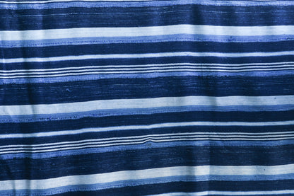 Handcrafted Textiles - Artisan Designed - Handcrafted African Art Textiles - Home Decor - Living Spaces - Mix Colors - Bold Patterns - Traditional Designs - African Culture - This Striped Textile is constructed from Vintage African Cotton material and is distinguished by its Indigo Dyed design. As a home decor accent, it adds a sophisticated yet bold touch to any living space. Length: 62 inches Width: 43 inches