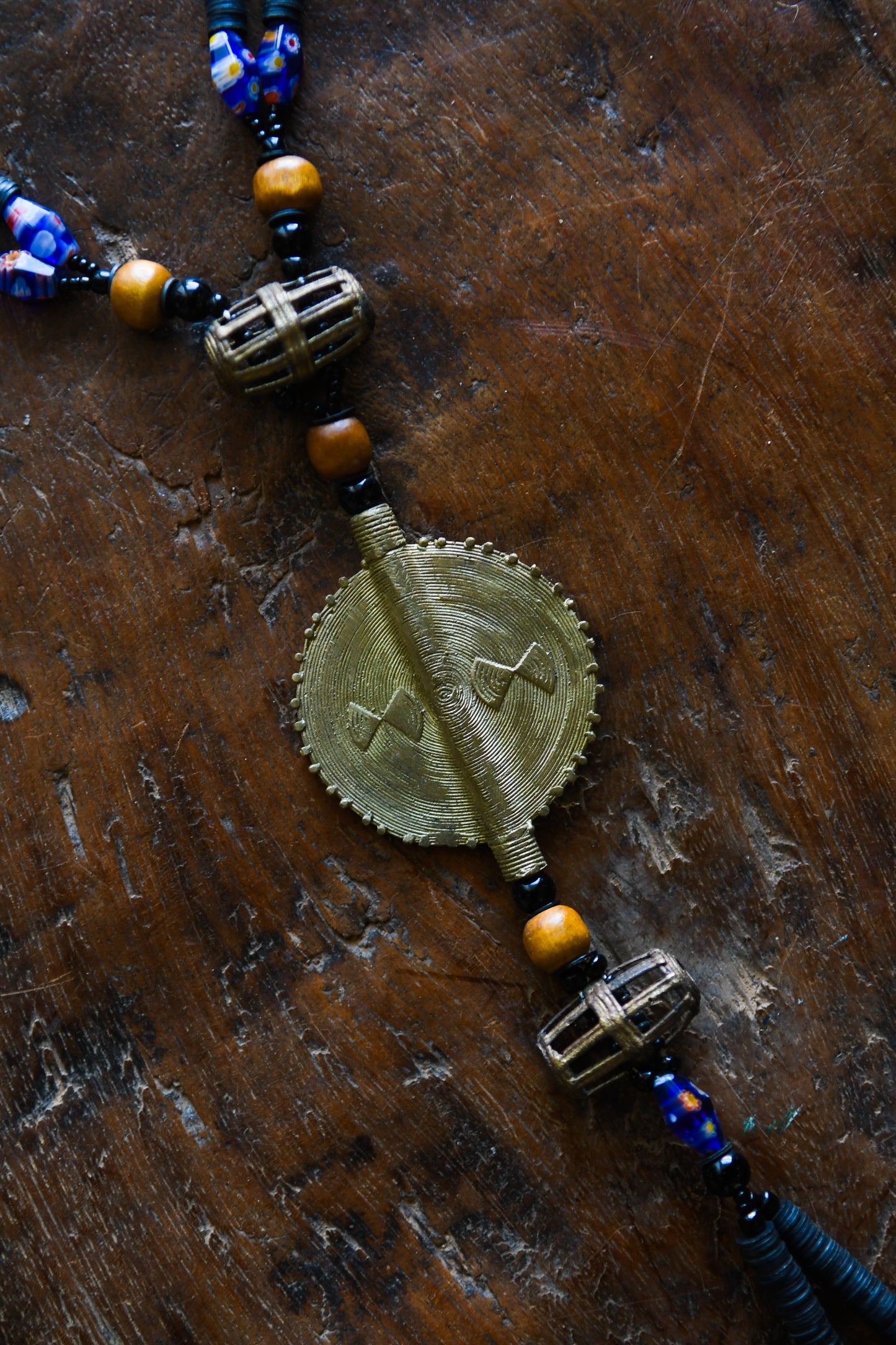 Tribal Necklaces - Handmade - African Art - Jewelry - Traditional - African Necklaces - Beaded - Collectible Necklaces - This Tribal Beads Bronze Pendant Necklace will add flair to any outfit. Crafted from bronze and featuring a unique African tribal design, it is sure to become a conversation starter. Enjoy this striking piece of jewelry and make a statement wherever you go. Length: 21 inches