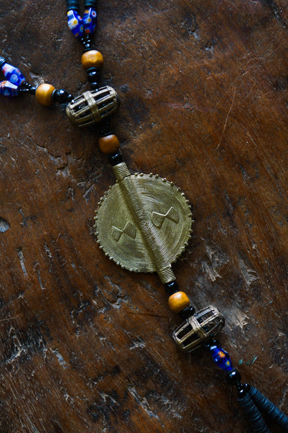 Tribal Necklaces - Handmade - African Art - Jewelry - Traditional - African Necklaces - Beaded - Collectible Necklaces - This Tribal Beads Bronze Pendant Necklace will add flair to any outfit. Crafted from bronze and featuring a unique African tribal design, it is sure to become a conversation starter. Enjoy this striking piece of jewelry and make a statement wherever you go. Length: 21 inches
