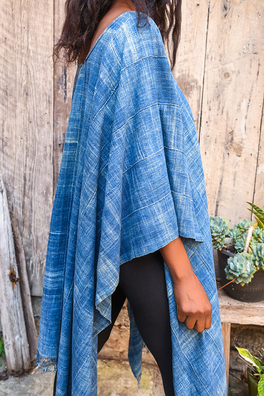 Experience traditional African style with our Faded Blue Indigo Poncho. Made with high-quality African textile, this poncho is both stylish and comfortable. Perfect for any occasion, the faded blue color adds a unique touch to any outfit. Elevate your wardrobe with this one-of-a-kind piece.