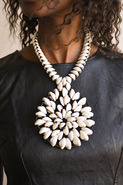 Handcrafted Necklaces - Handmade - African Art - Jewelry - Beaded Necklaces - This Statement African Jewelry Necklace is handmade and features an authentic Cowrie Shell Beads Pendant. Its intricate design adds to any look, making it a classic and chic closet staple. Length: 14 inches Inventory # 10831