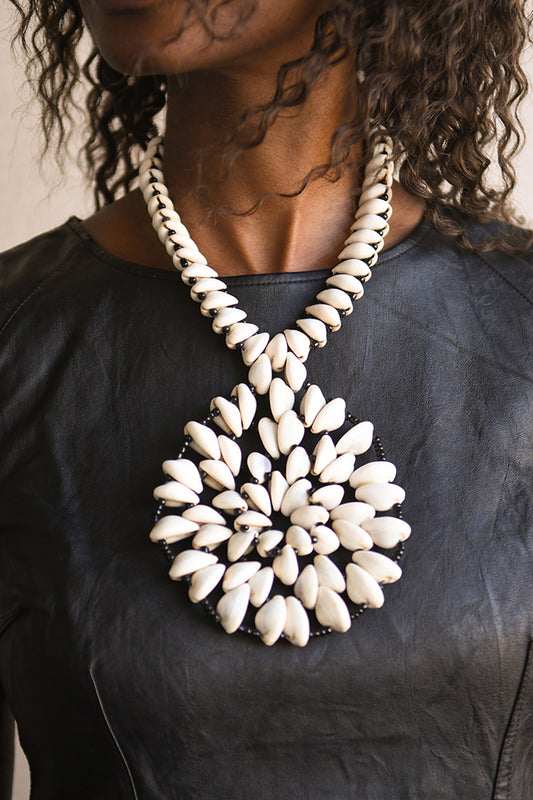 Handcrafted Necklaces - Handmade - African Art - Jewelry - Beaded Necklaces - This Statement African Jewelry Necklace is handmade and features an authentic Cowrie Shell Beads Pendant. Its intricate design adds to any look, making it a classic and chic closet staple. Length: 14 inches Inventory # 10831