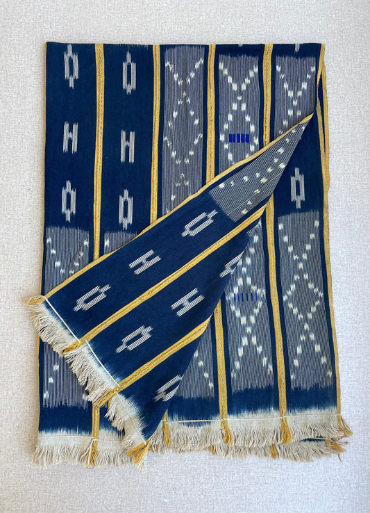 Handcrafted Textiles - African Art - Indigo Textiles - Traditional Designs - Home Decor - Living Spaces - This African Baule fabric is made of high-quality, authentically dyed cotton. Featuring an intricate blue and yellow ikat pattern, this fabric is sure to be the perfect decorative addition to any home. Add a unique vintage touch to any project with this authentic African textile. Length: 57” Width: 41”